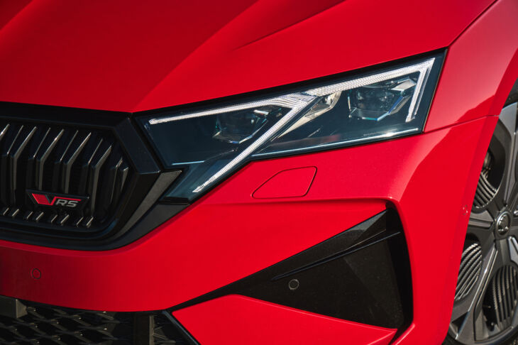 Close-up of the headlight and front grille of the 2025 Skoda Octavia RS in red