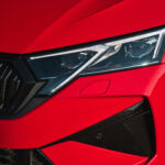 Close-up of the headlight and front grille of the 2025 Skoda Octavia RS in red