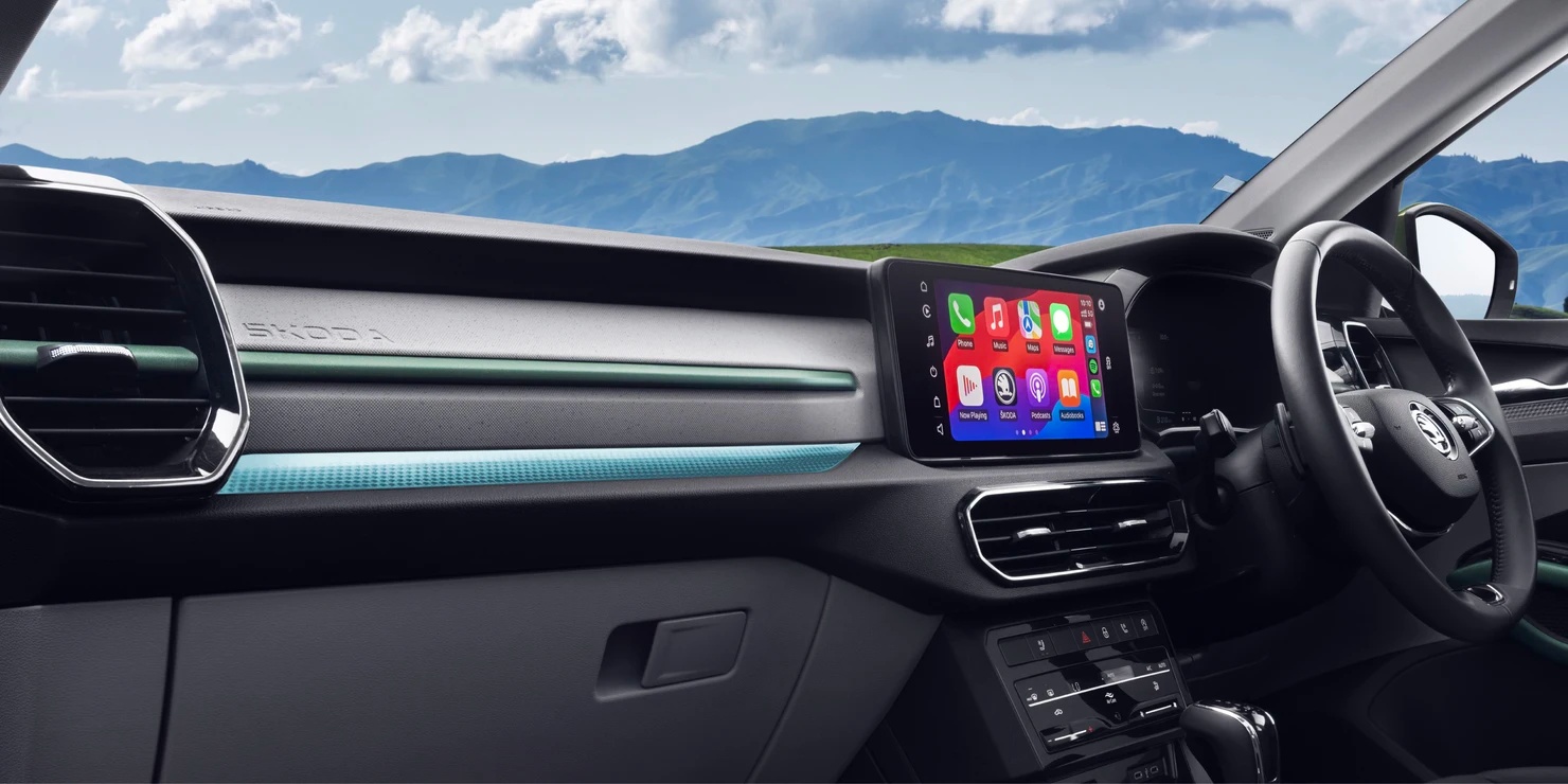 Close-up of Škoda Kylaq dashboard featuring Škoda branding and ambient lighting