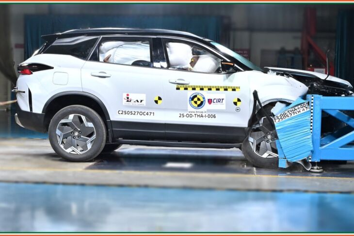Frontal crash test of Tata Harrier EV with dummies and deployed airbags visible.