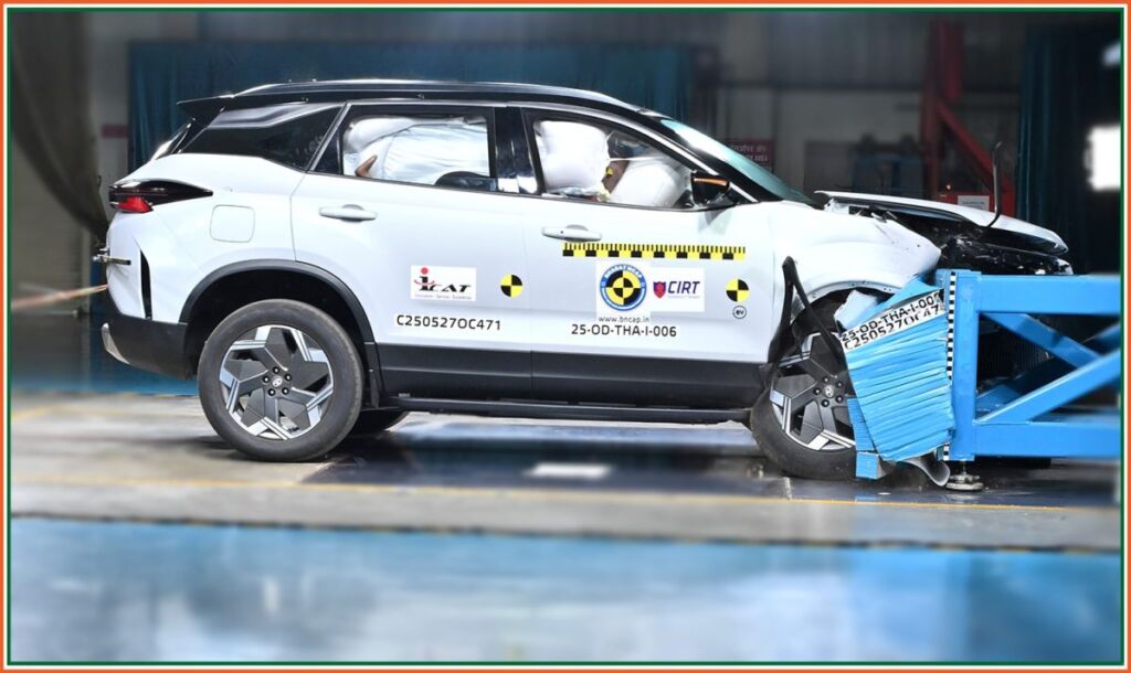 Frontal crash test of Tata Harrier EV with dummies and deployed airbags visible.