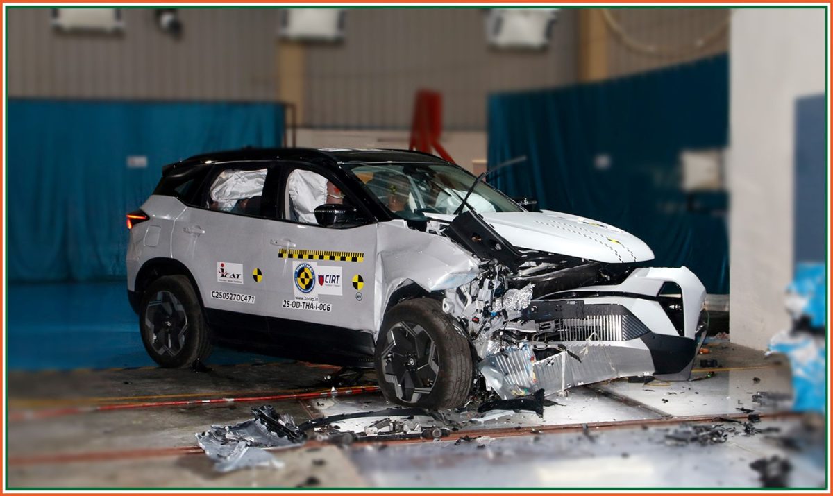 Post-crash image of Tata Harrier EV after frontal impact test showing extensive front-end damage and deployed airbags.