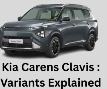 Kia Carens Clavis front three-quarter view in metallic grey with bold styling and LED headlamps