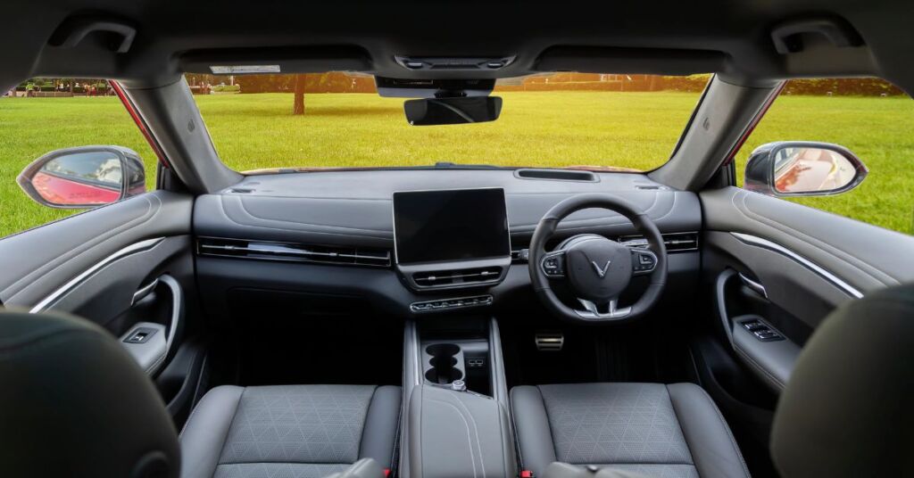 Interior of the Vinfast VF7 with a big touchscreen angled towards the driver