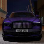 Front view of Rolls-Royce Spectre in purple under urban night lights