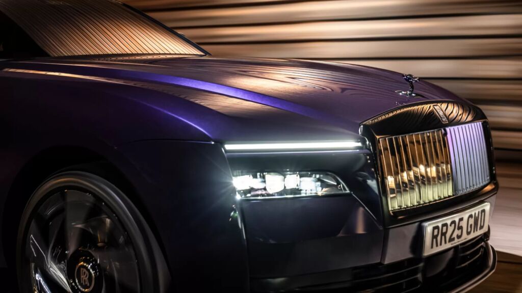Rolls-Royce Spectre headlamp and grille in motion with light reflections