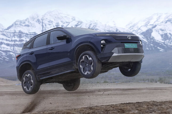 Tata Harrier EV airborne during an off-road test with snow-capped mountains in the background