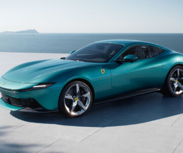 Front-side view of the Ferrari Amalfi in turquoise by the seaside