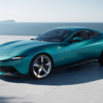 Front-side view of the Ferrari Amalfi in turquoise by the seaside