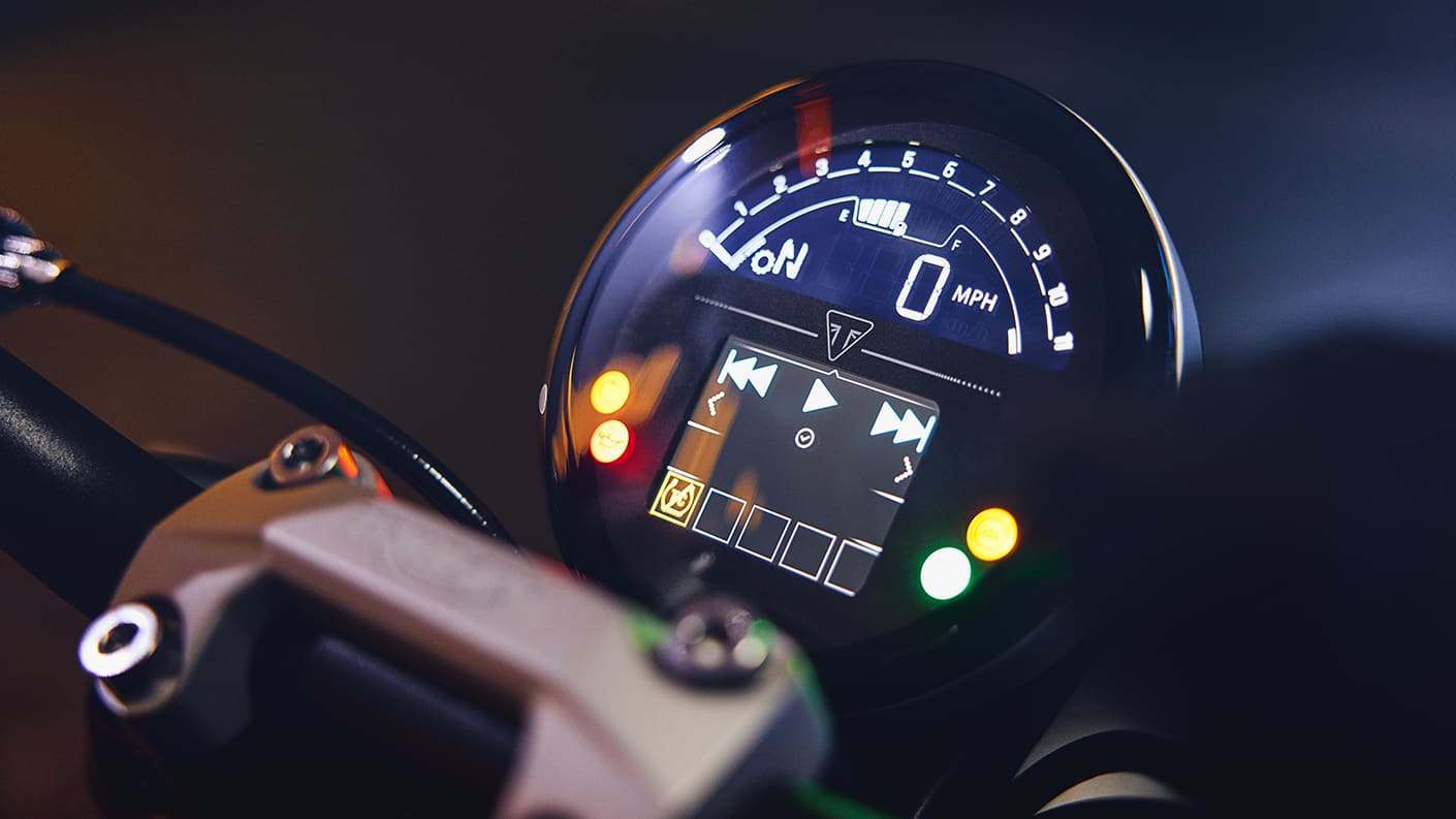 Close-up of the 2025 Triumph Trident 660 handlebar and switchgear, highlighting the new cruise control button and TFT instrument cluster