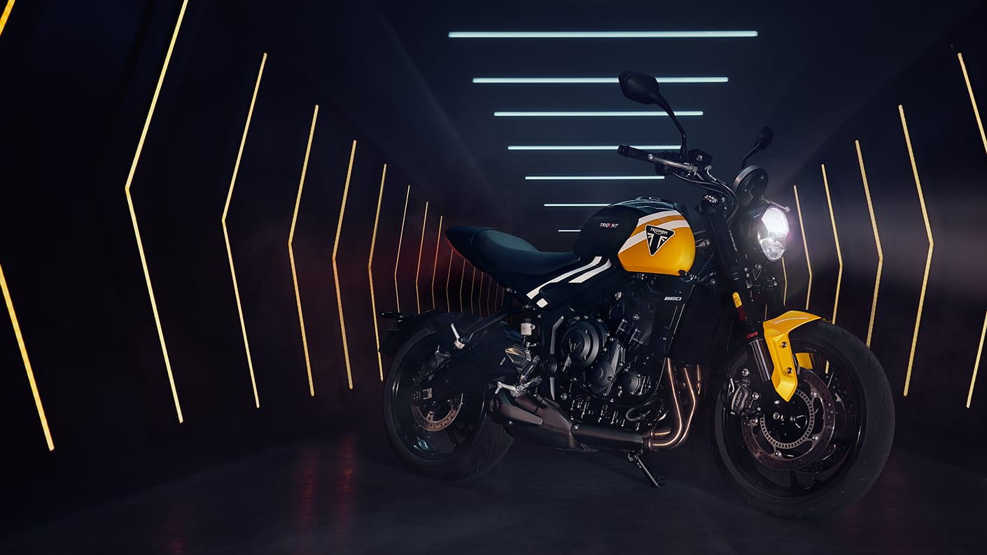2025 Triumph Trident 660 in yellow-black dual-tone paint, studio shot showcasing front-left angle with sharp tank lines and LED headlamp