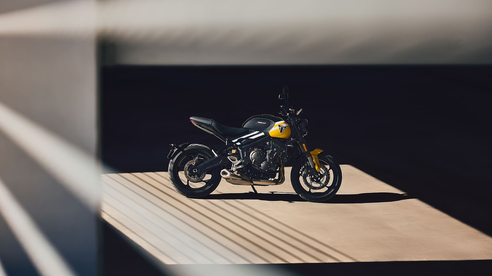 Dynamic shot of the 2025 Triumph Trident 660 cornering on a twisty road, showcasing Michelin Road 5 tyres and new Showa front forks in action